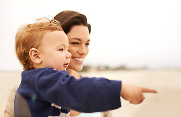 Image showing Happy mother, beach and baby pointing for fun bonding, holiday or outdoor weekend together in nature. Face of mom, little boy or toddler with smile, enjoying sightseeing or travel by the ocean coast