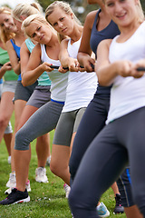 Image showing Team, women and friends in tug of war with group, strong and balance with pull for challenge on field. People, exercise and training with rope for games, contest or competition with muscle on grass