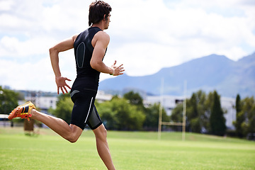 Image showing Athlete male person, run and outdoor for race, jog and activewear in workout and training for wellness and sprint. Cardio, wellbeing and sport for exercise, health and fitness on grass for summer