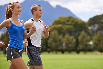 Image showing Man, woman and running for exercise on field with smile for speed, wellness and training in summer. People, coach or personal trainer with runner for workout, fitness and together on grass for health