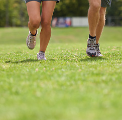 Image showing People, running shoes and closeup on grass for workout together in summer for health, wellness or training. Person, runner and partner with feet on field for exercise, fitness and speed with sneakers