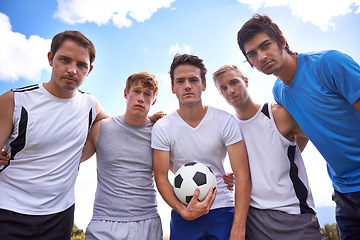 Image showing Soccer player, team and portrait in low angle, outdoor and together with hug for training, exercise or workout. People, sports and football with scrum, embrace and solidarity for game in competition