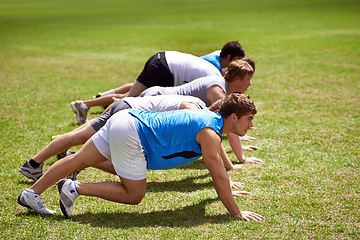 Image showing Team, running and start of competition in outdoors, sprint and training on sports field for race. People, athletes and cardio challenge on grass for workout, performance and ready by starting line