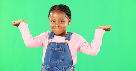 Image showing Little girl, face and clueless with smile on green screen for question against a studio background. Portrait of African American child or kid smiling with arms in air, unsure or doubt on mockup