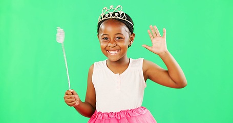Image showing Children, wave and wand with a girl on a green screen background in studio playing fantasy or dress up. Portrait, kids and magic with an adorable little female child waving on chromakey background