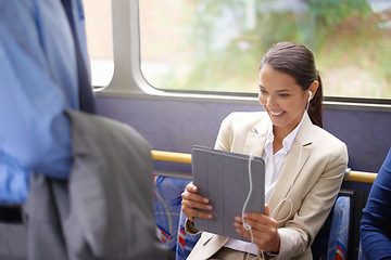 Image showing Woman, bus and earphones for music on tablet, public transportation and reading on social media. Female person, internet and playlist on metro or transit, happy and commute with tech and travel