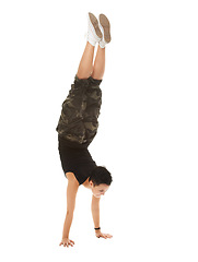 Image showing Teenager, acrobat and studio fashion handstand, casual and cool isolated on white background. Street, style and dance movement for strength, breakdance with edgy hip hop gymnast in trendy exercise