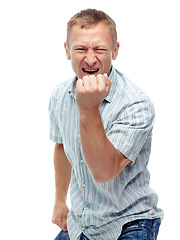 Image showing Man, fist and winning in studio portrait with success, goals and financial freedom by white background. Person, celebration and excited for achievement, prize and competition with cheers for giveaway