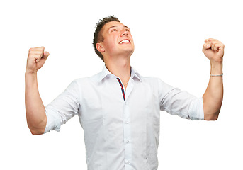 Image showing Man, happy and fist celebration in studio with success, goals and financial freedom by white background. Person, winner and excited for achievement, prize and competition with cheers for giveaway