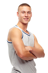 Image showing Portrait, fitness and smile with man arms folded in studio isolated on white background for sports. Exercise, health and workout with confident young athlete in tank top for strong muscle training