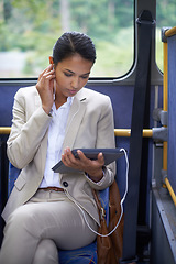 Image showing Woman, streaming and travel on bus with tablet and earphones for journey and transport in outdoor. Business person and research with formal clothes and tech online for communication and commute