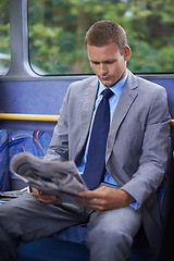 Image showing Newspaper, public transport and business man on bus for morning commute to work for start of career or job. Employment, profession and work with young passenger reading on shuttle in city for transit