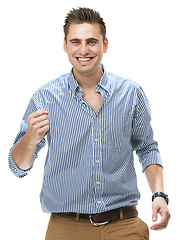 Image showing Portrait, happy and man in celebration for success, winning and goal achievement in studio isolated on a white background. Person, cheers and fist pump to smile for victory, promotion or bonus prize