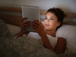 Image showing Woman, tablet and browsing at night, scrolling and entertainment with tech and relaxing for peace before sleep. Female person, browsing and online for home, internet and elearning or social media