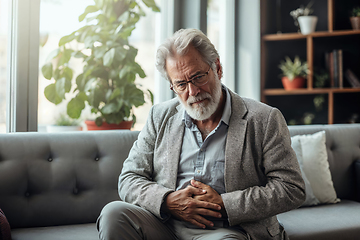 Image showing Senior Man Contemplating Alone on a Sofa at Home