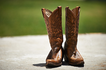 Image showing Cowboy, boots and vintage in outdoor fashion, shoes and leather for horse riding. Countryside, style and design for footwear with pattern, stitching and western landscape or grassland and farm