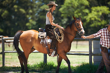 Image showing Female woman, horse and farm with cowboy, stable and ranch in Texas for pony riding. Stallion, mare and animal paddock for equestrian learning, countryside and lessons for sports for beginner rider