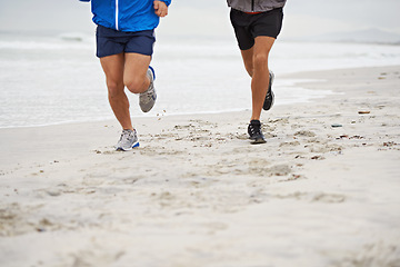 Image showing Beach, legs or friends running for exercise, wellness or training outdoor in nature to workout for body health. Ocean, shoes or people together for fitness, cardio or jog for sport with energy at sea