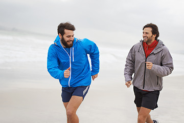 Image showing Laugh, men and running on beach, sand and fitness for wellness and gym wear on ocean coast workout. Male athletes, jog and training for seaside, health and outdoor for sport and exercise together
