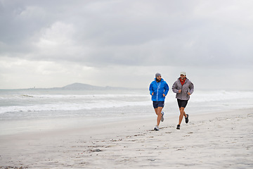 Image showing Men, ocean and running on beach, sand and fitness for wellness and gym wear on coast together. Male athletes, jog and training for seaside, health and outdoor for sport and exercise for body workout
