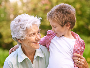 Image showing Grandmother, grandchild and hug with nature, love and smile with joy for happiness and together. Woman, child and park with embrace, bonding and family with care and childhood for retirement