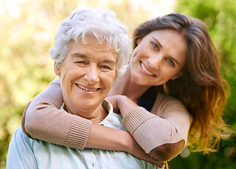 Image showing Mother, daughter and hug with backyard, love and smile with portrait for relationship and happiness. Mature woman, adult and nature with embrace, bonding and family with care and retirement in park