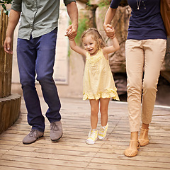 Image showing Happy, little girl and holding hands with parents for bonding, adventure or field trip. Excited child or kid walking with mom and dad in travel for fun holiday, weekend or sightseeing together