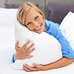 Image showing Woman, bed and portrait with head on pillow in hotel room or indoors for vacation, calm and sleep. Happy person and smile for waking up and laying for comfort, rest and stress relief on holiday