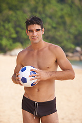 Image showing Beach, portrait and shirtless man with soccer ball in nature for fun summer, weekend break or outdoor vacation. Ocean, swimwear and male person by football for adventure, happiness and sunshine.