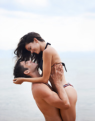 Image showing Couple, beach and ocean with love, smile and romance with swimwear and bikini. Man, woman and date with holiday, vacation and adventure with nature for cape town summer travel and happiness for trip