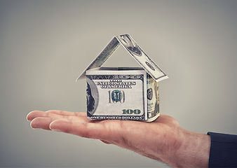 Image showing Hand, cash and finance for house in studio with shape for security, real estate or investment by background. Home, insurance with money, dollars and symbol for property, mortgage or rent of building