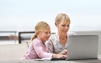 Image showing Mother, child and laptop on a patio with elearning, game and internet with love, support and bonding. Tech, smile and mom with teaching and education app with young girl on a website for home school