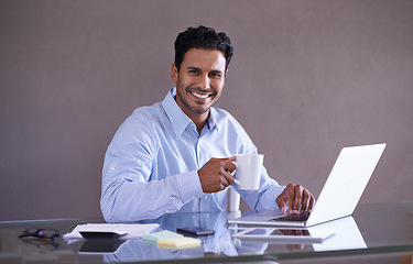 Image showing Businessman, laptop and portrait by desk for coffee, relax and social media with browse for online research. Entrepreneur, smile face and technology at work, wellness and tea break in startup company