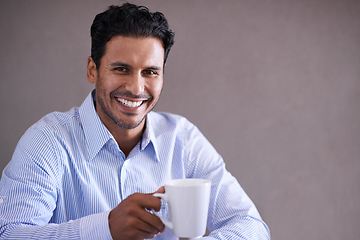 Image showing Indian businessman, coffee and smile portrait on work break, professional and happy isolated on grey background. Stock broker, finance and accounting or management at firm, investment and corporate