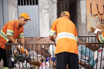 Image showing Waste, people and workers for municipal cleaning garbage on streets of urban city. Employees, service and orange uniform for job of trash collection, bags and plastic pollution in environment