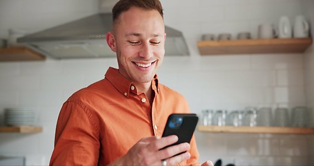 Image showing Man, kitchen and typing on phone or browsing social media at home, happy and relaxing on weekend. Happy male person, communication and mobile application for online conversation, humor and laughing