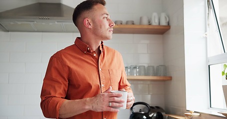Image showing Man, drinking coffee and daydreaming or thinking at home, peace and relaxing or calm in kitchen. Male person, beverage and hot tea for comfort, window and reflection or inspiration and mug for future
