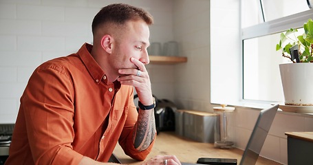 Image showing Man, thinking and typing on laptop at home, planning and reflection by kitchen window in apartment. Male person, freelancer and contemplating ideas or online research, website and remote work or job