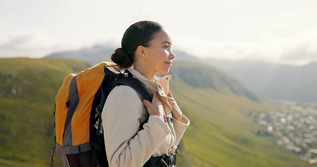 Image showing Young woman, trekking on mountains and breathing fresh air for outdoor wellness, fitness and health. Happy person in wind with backpack and hiking in nature on a hill for adventure, travel or journey