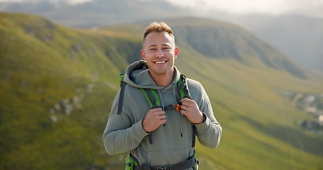 Image showing Happy man, face and backpack with mountain for hiking, adventure or outdoor journey in nature. Portrait of male person, tourist or hiker smile with bag for trekking or climbing on cliff or hills