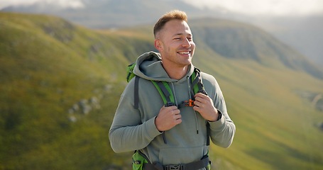 Image showing Happy man, face and backpack with mountain in nature for hiking, adventure or outdoor journey. Male person, tourist or hiker smile with bag for trekking, sightseeing or fresh air on cliff or hills