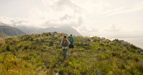 Image showing Back of couple trekking, walking on mountains and travel for adventure, wellness and health in nature together. Sports people with backpack for hiking on rocks, green hill and eco friendly journey