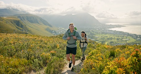 Image showing Couple of friends walking, hiking on mountain and travel for fitness, adventure or journey in nature for wellness. Young people trekking with backpack on a path or green hill for cardio and health