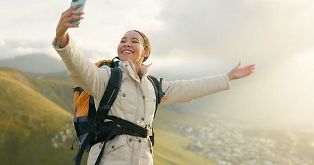 Image showing Woman, trekking on mountains and selfie or video call for hiking, adventure and eco friendly blog on social media. Vlogger or influencer with live stream, travel or journey on a hill, rock and nature