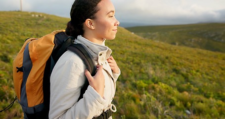 Image showing Young woman, hiking on mountain and breathing fresh air for outdoor wellness, fitness and health. Happy person in wind with backpack and trekking in nature on a hill for adventure, travel or journey
