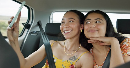 Image showing Woman, friends and selfie on road trip with smile, tongue and funny face with adventure in car. Girl, photography and kiss with care, journey or holiday with memory, profile picture or transportation