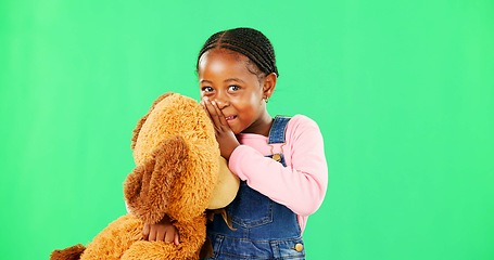 Image showing Child, teddy bear and smile by green screen in portrait for whisper, gossip or story with mockup for promo. African girl, kid and happy with toys for talk, secret or playful with conversation in game