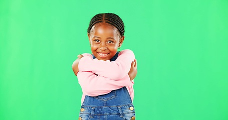 Image showing Girl, child and smile with hug for self love in portrait with fashion, pride and empowerment by green screen. African kid, happy and embrace with kindness, excited or growth with mockup for promotion