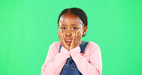 Image showing Portrait, sad and kid on green screen in studio isolated on a mockup space background. Face, hands or unhappy African girl child on chroma key, depression or disappointed facial expression of emotion