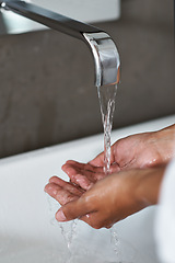 Image showing Handwashing, water and person in bathroom for hygiene, wellness and safety from germs or bacteria in home. Cleaning hands, liquid and self care with skincare, disinfection and splash in sink